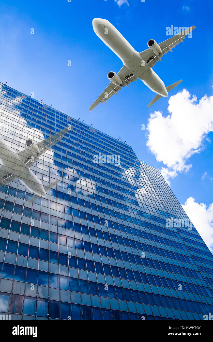 Skyscrapers with a flying airplane against blue sky Stock Photo - Alamy