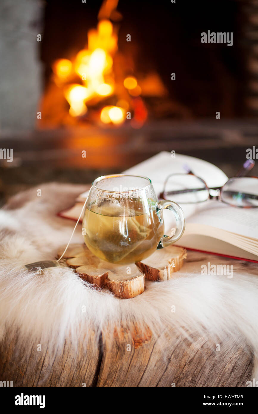 Cup of tea by the fireplace Stock Photo