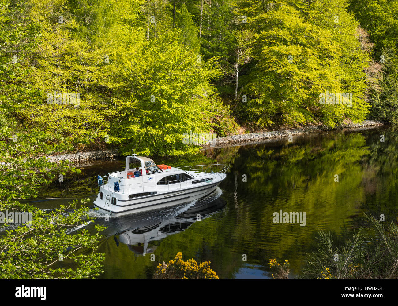 Motor boat cruising Laggan Avenue, Caledonian Canal, Highlands, Scotland, UK. Stock Photo