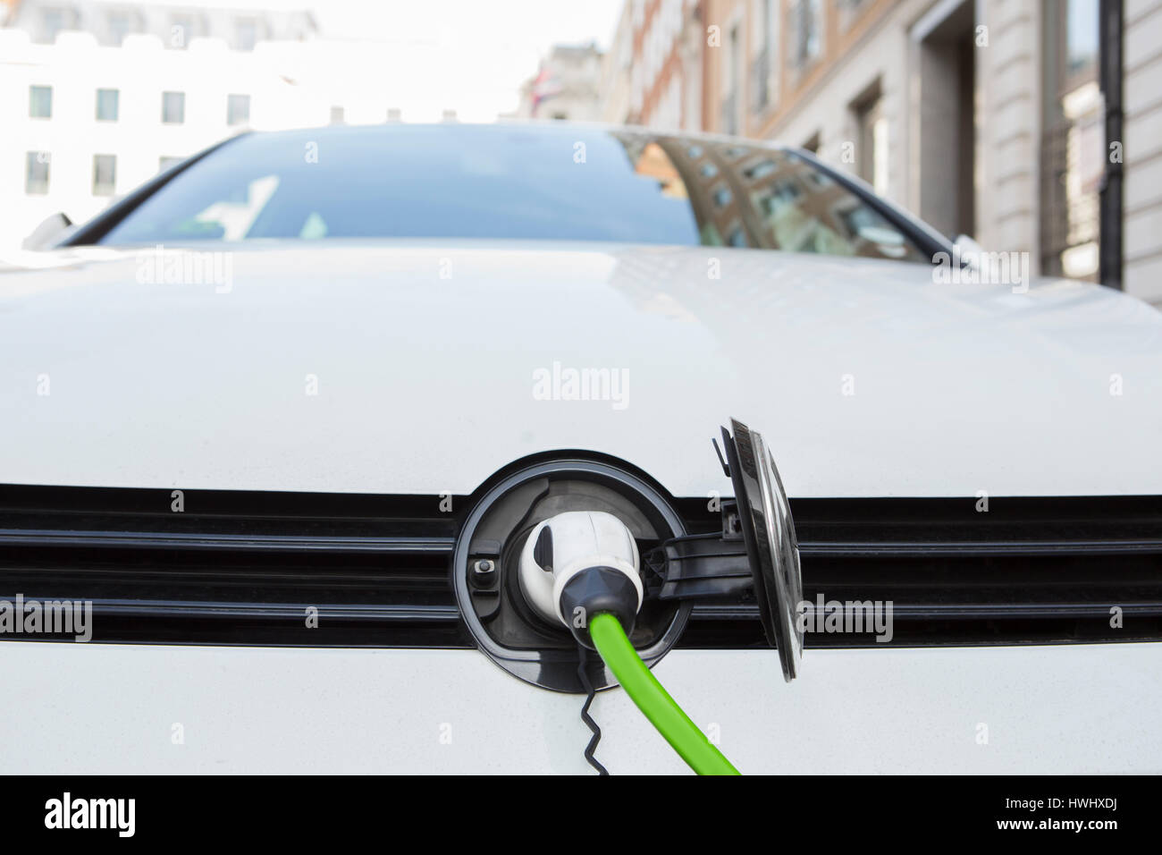 Close Up Of Electric Car Being Charged Stock Photo