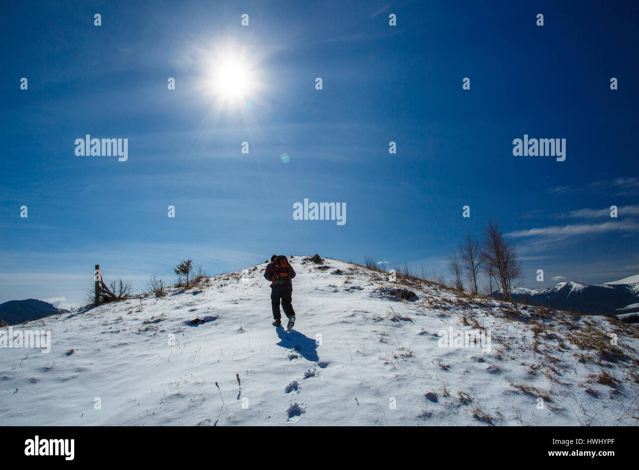 tourist goes on snowy mountain top Stock Photo