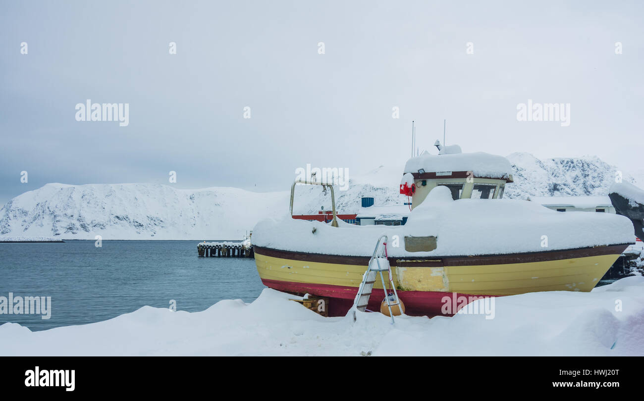 A small boat covered by the snow at Honninsvag in Norway Stock Photo