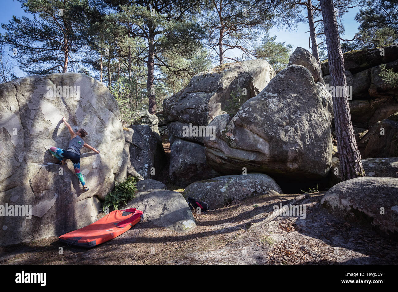 Professional climber Zofia Reych bouldering in the forest of