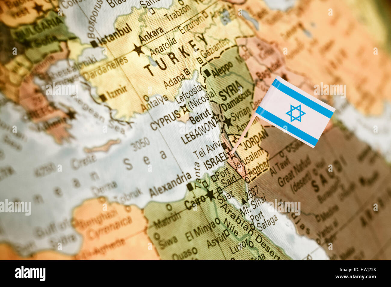 map with miniature flag of Israel .Selective focus on Israeli Flag.  Detail Globe Backlit lighting Stock Photo