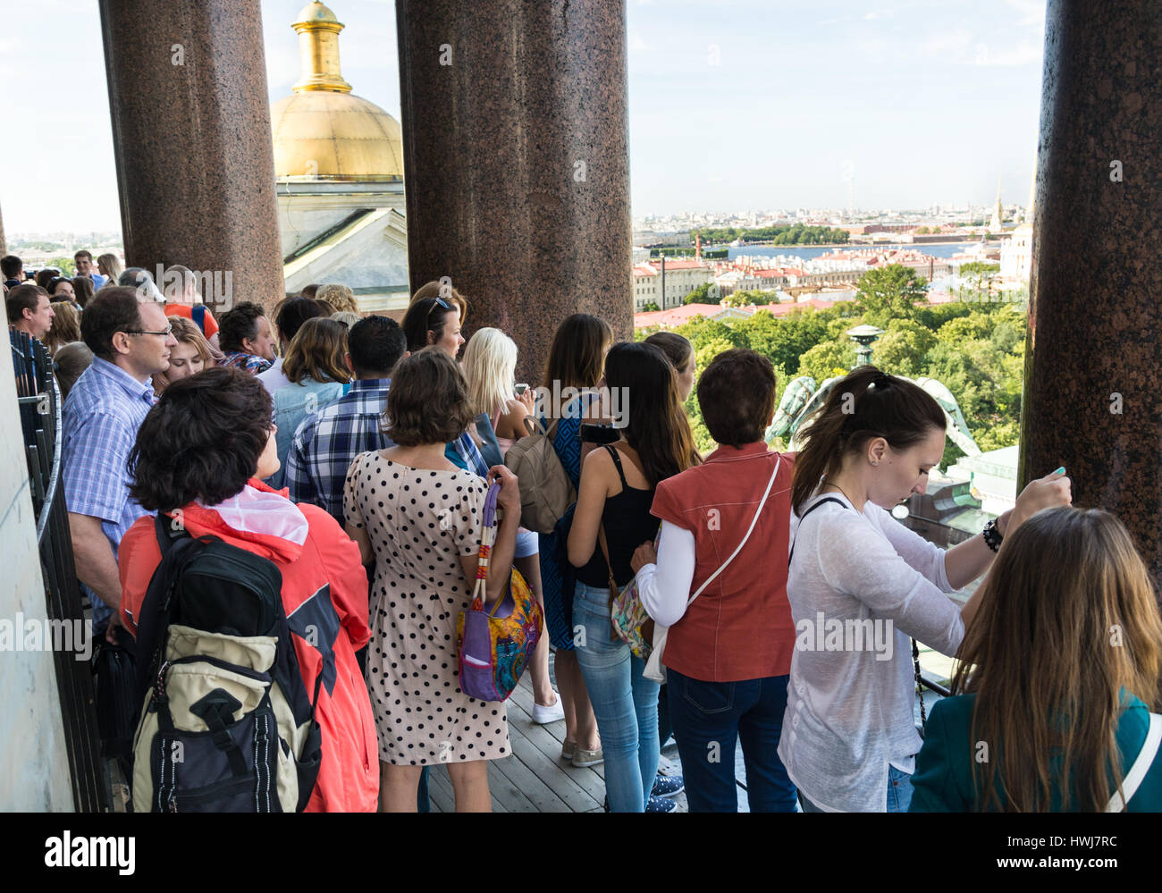 ST. PETERSBURG, RUSSIA - JULY 14, 2016: Tourists admire the view of St. Petersburg on the upper colonnade of St. Isaac's Cathedral Stock Photo