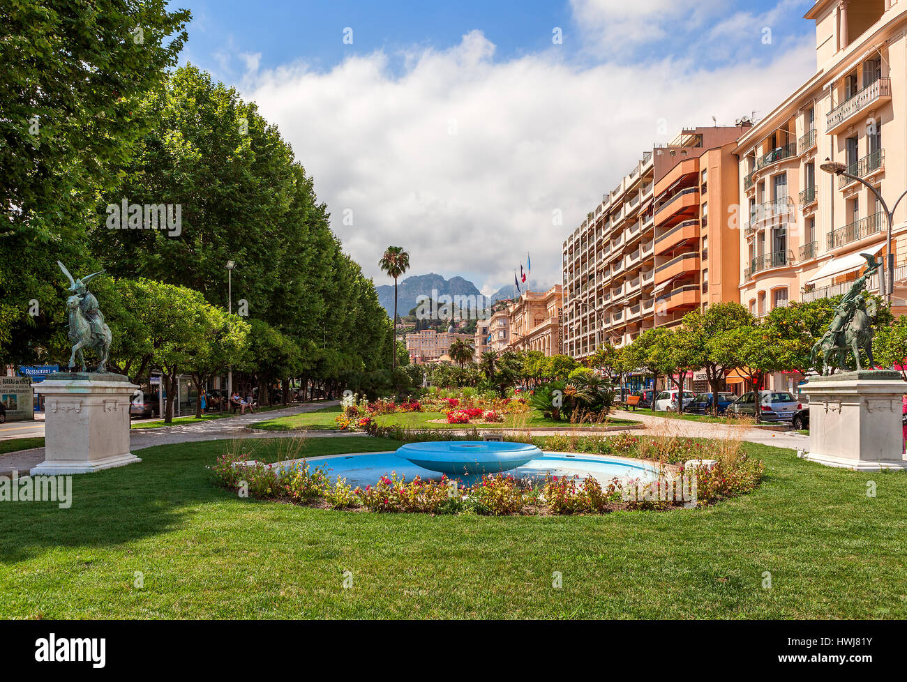 MENTON, FRANCE - JULY 07, 2012: View of green urban park along street and colorful buildings in center of Menton - small town on French Riviera, famou Stock Photo