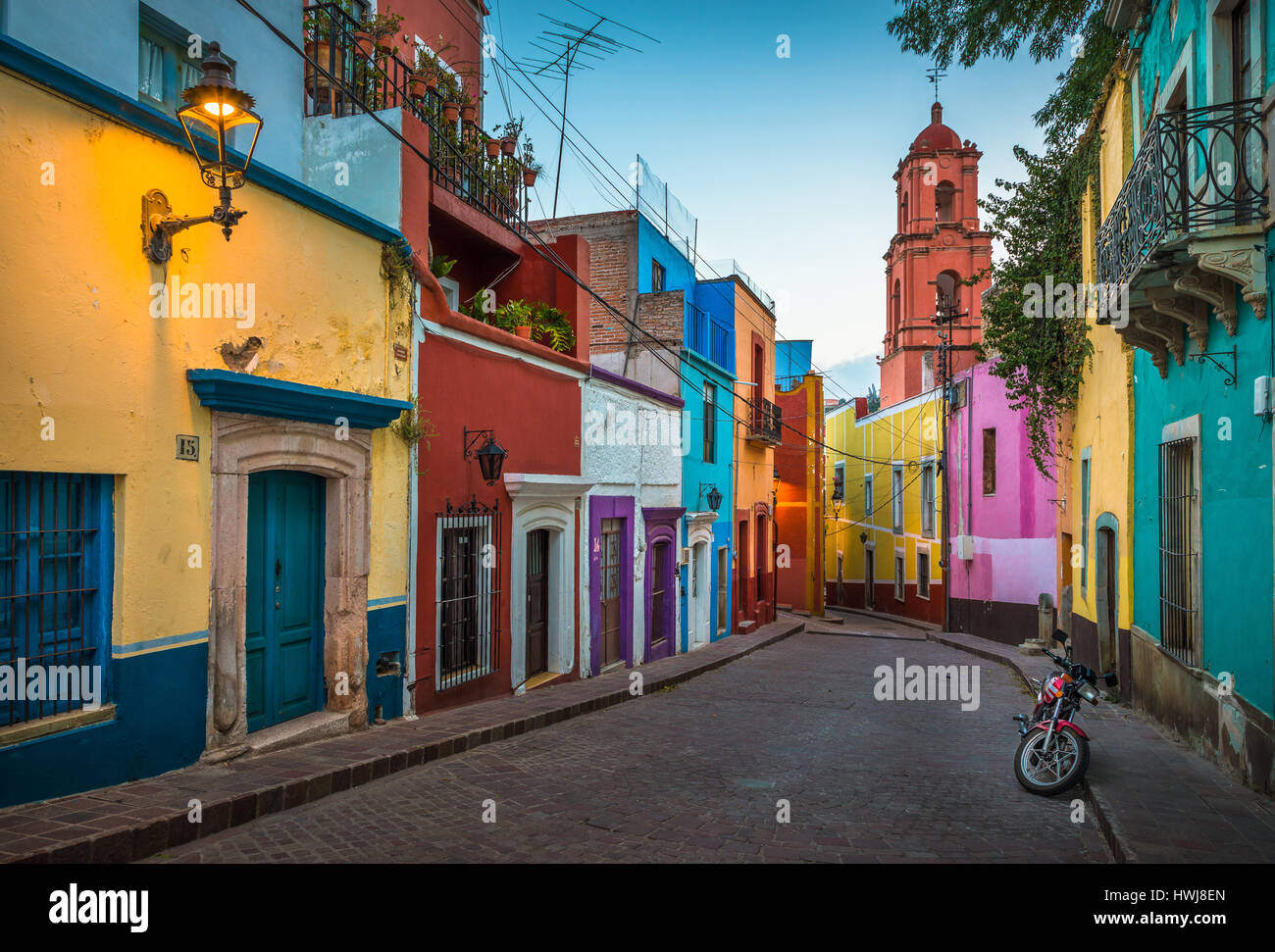 Motorcycle on a picturesque street in the historic center of Guanajuato, Mexico ------ Guanajuato is a city and municipality in central Mexico and the Stock Photo