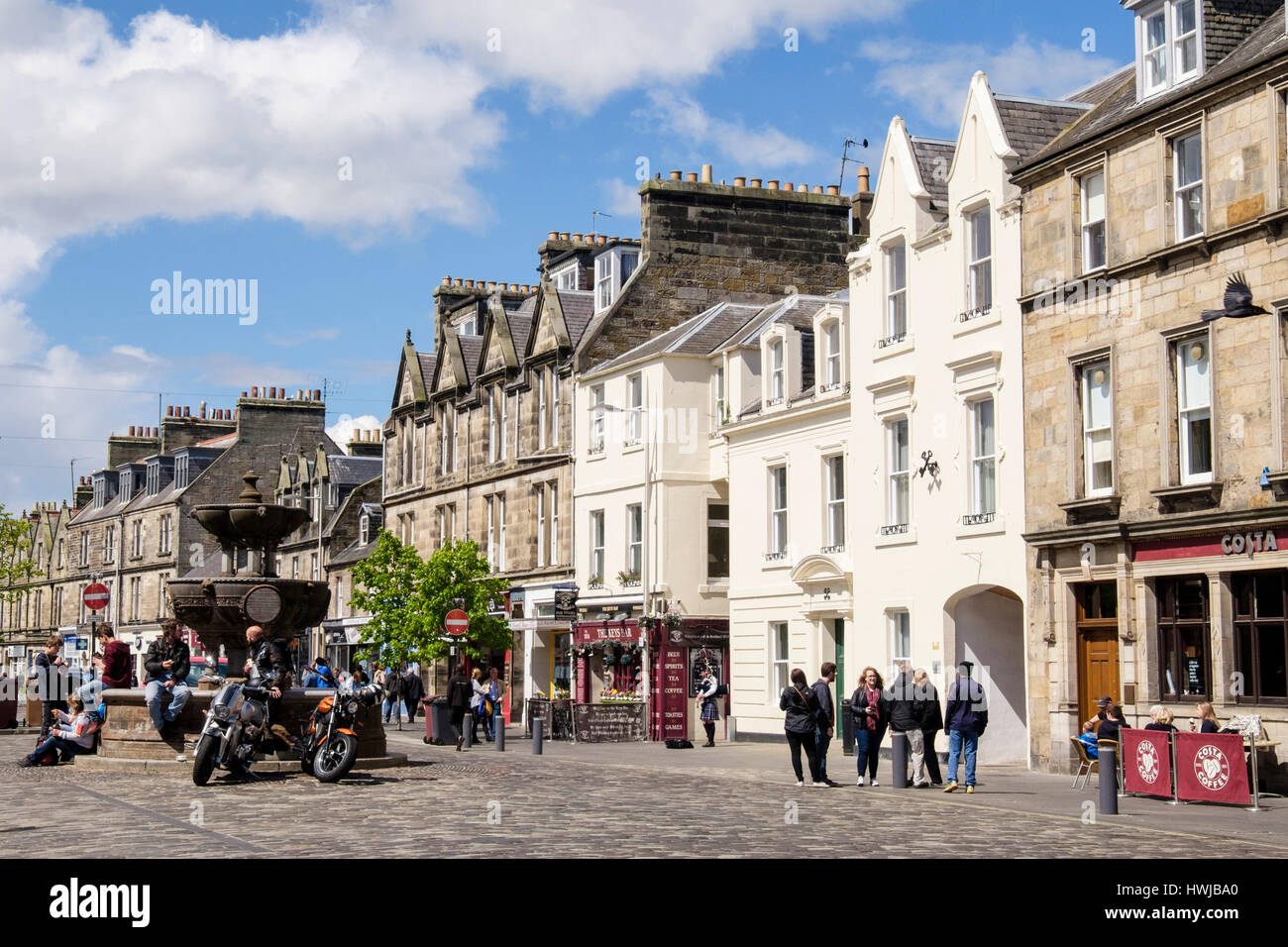 Street scene by small shops in town centre in summer. Market Street, Royal Burgh St Andrews, Fife, Scotland, UK, Britain Stock Photo