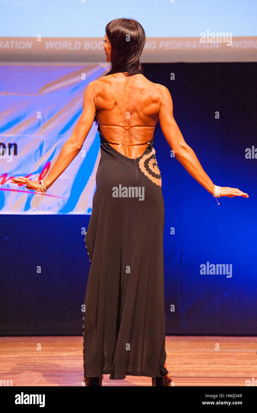 MAASTRICHT, THE NETHERLANDS - OCTOBER 25, 2015: Female figure model in evening dress shows her best in championship on stage at the World Grandprix Bo Stock Photo