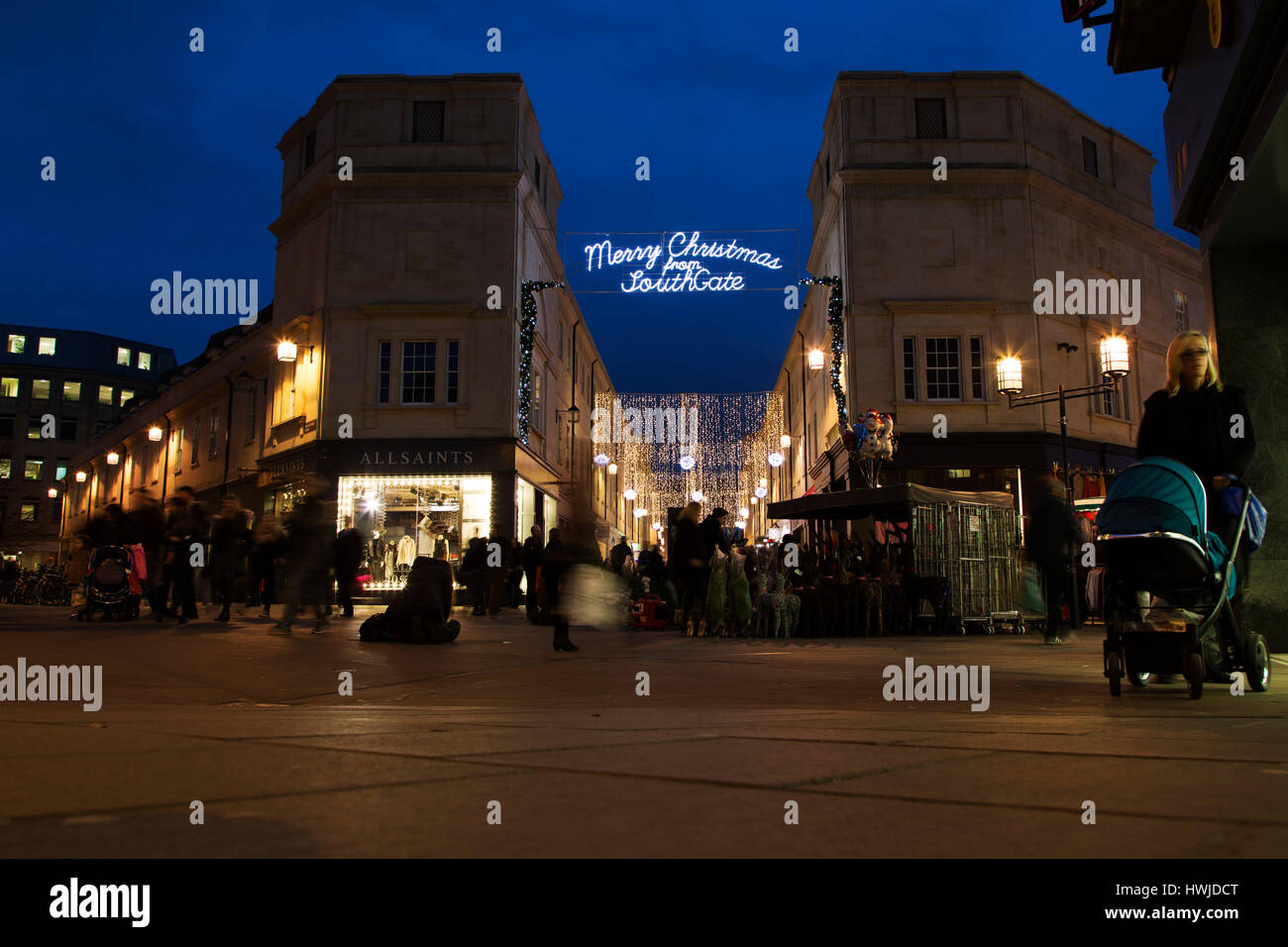 Late night Christmas shopping in Bath, England. A sign says 'Merry