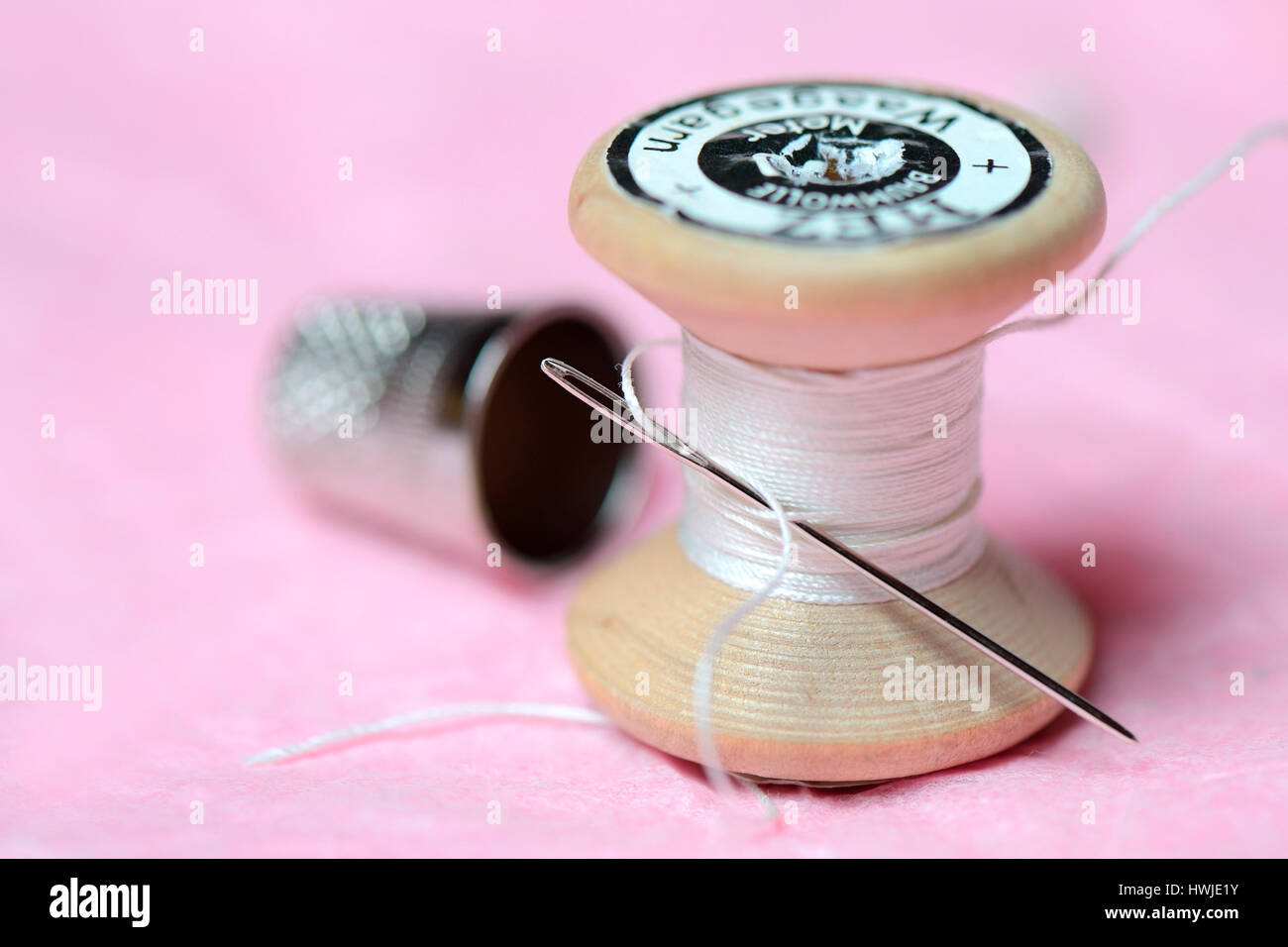thimble, sewing needle and cotton reel Stock Photo