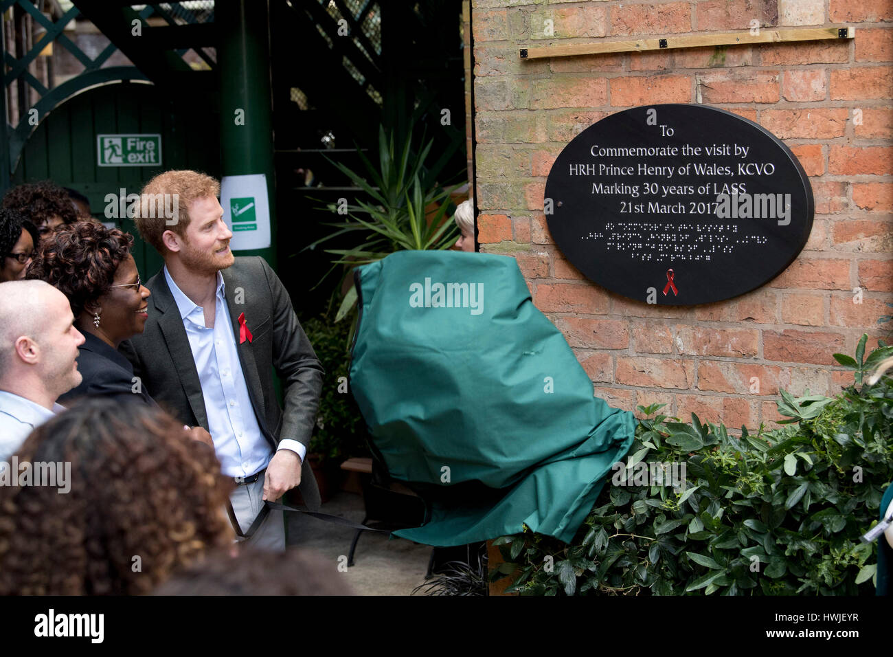 Prince Harry unveils a plaque on a visit to the Leicestershire Aids