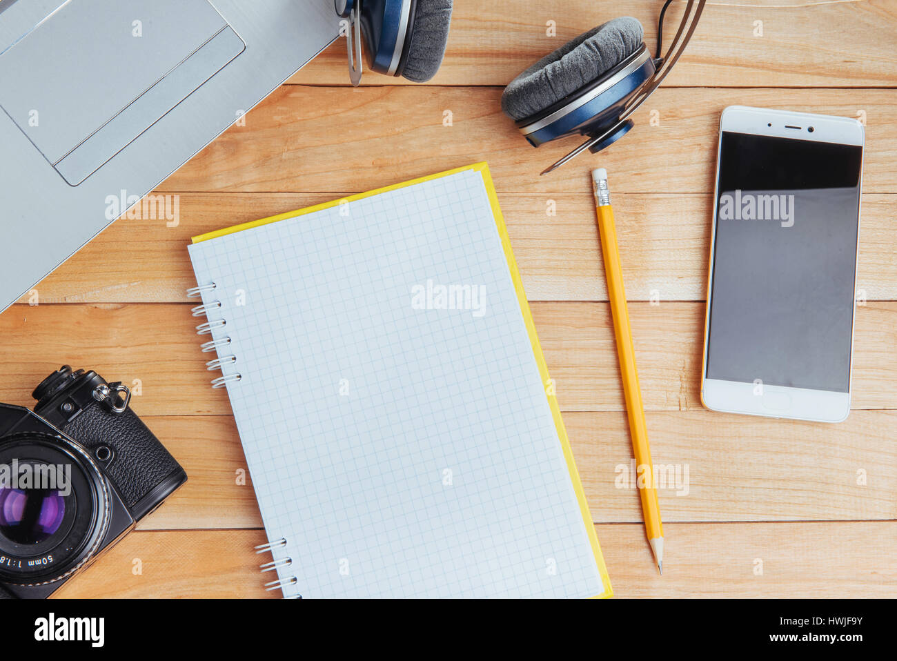 Top view of notebook, stationery, drawing tools and a few glasses