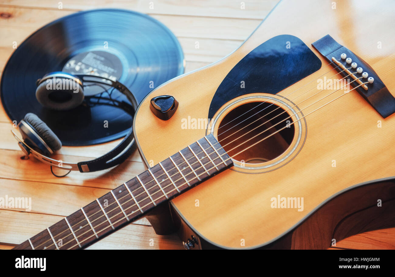 Classical guitar with headphones on a wooden background Stock Photo Alamy
