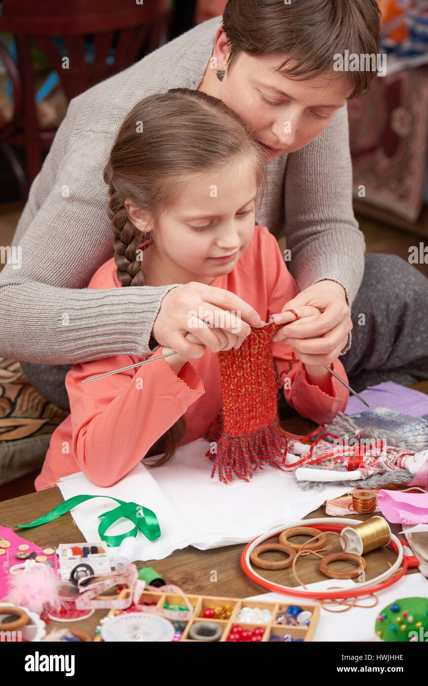 mother teaching daughter girl knit, job training, handmade and