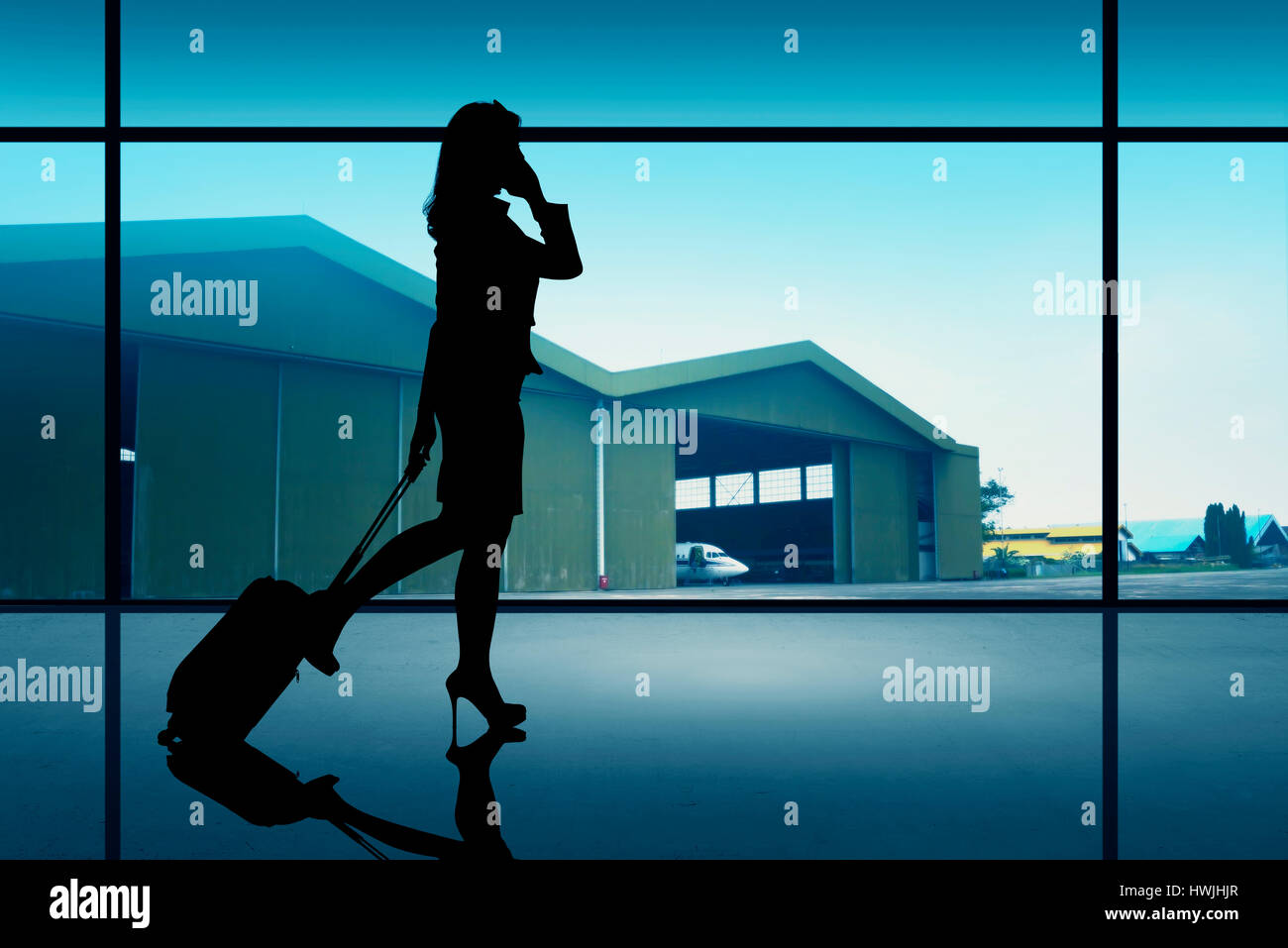 Silhouette of traveler woman walking on the airport Stock Photo