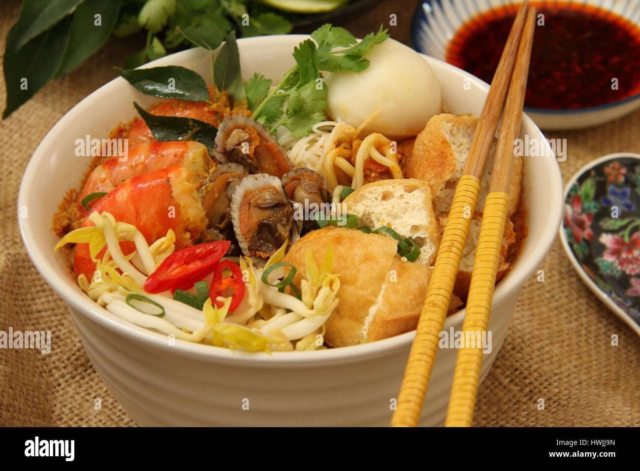 Curry Laksa. Peranakan curry noodle soup with seafood, bean curds, and