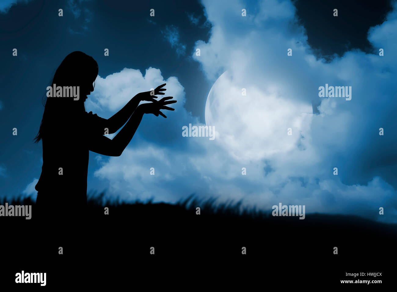 Silhouette of woman zombie walking under full moon. Halloween concept Stock Photo