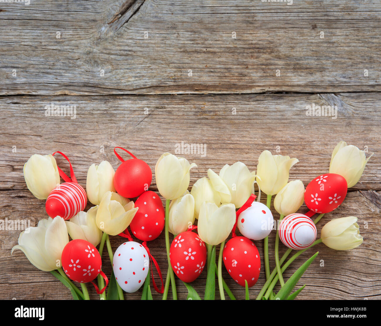 Easter eggs and tulips on wooden background with copy space Stock Photo ...