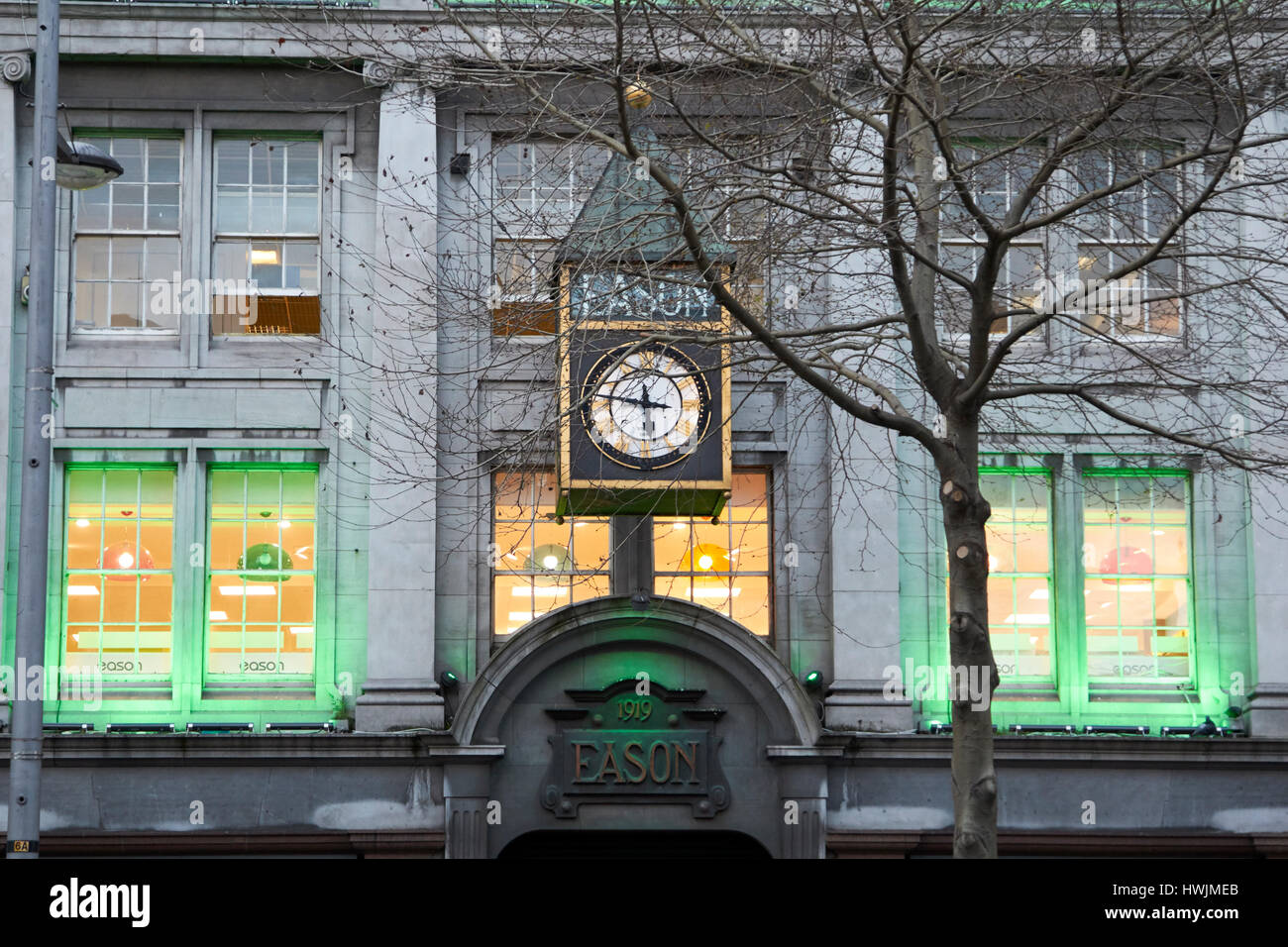 eason clock on eason building in oconnell street lit green for st patricks day Dublin Republic of Ireland Stock Photo