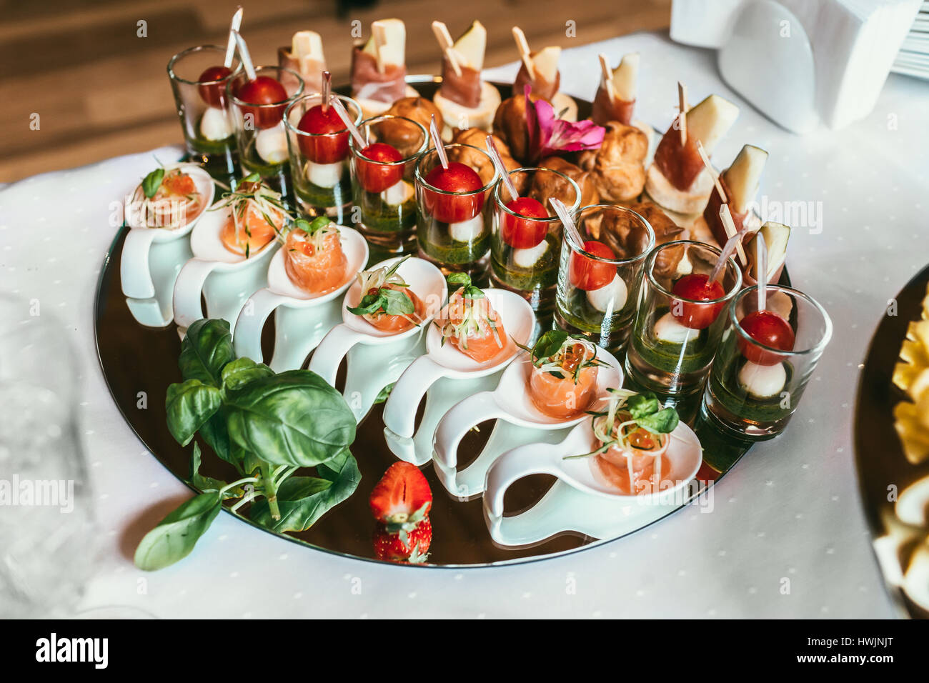 Delicious sushi rolls on black plate, decorated fruit snacks Stock Photo