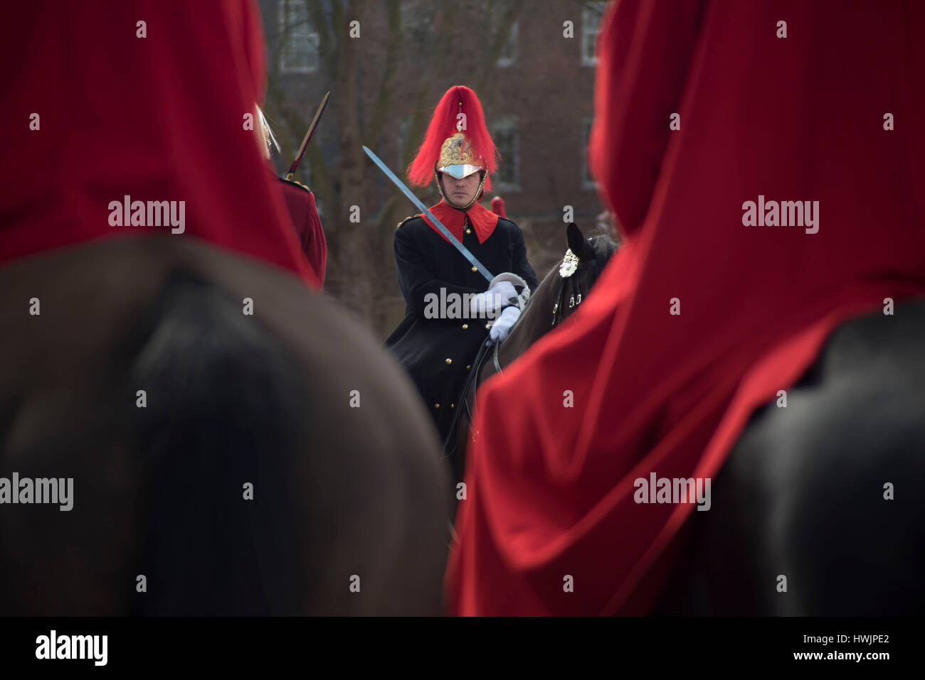 London, UK. 21st Mar, 2017. The queen's life guard is normally provided by men of the household cavalry mounted regiment which consists of a squadron of the life guards, who wear red tunics and white plumed helmets, and a squadron of the blues and royals with blue tunics and red plumed helmets. Credit: Alberto Pezzali/Pacific Press/Alamy Live News Stock Photo