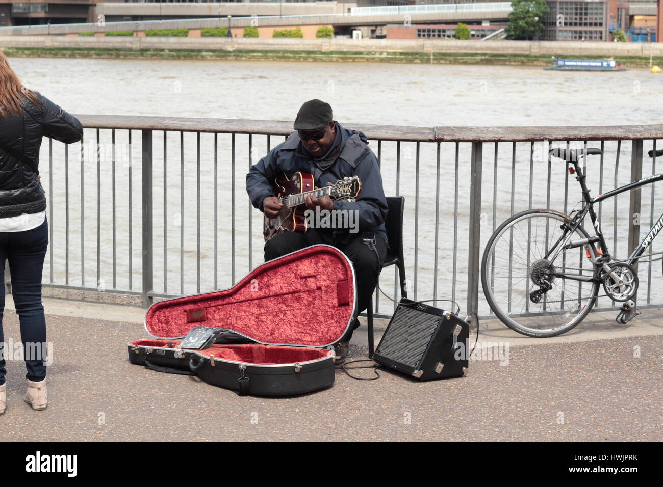 busker on south bank of river thames in London playing the blues on electric guitar Stock Photo