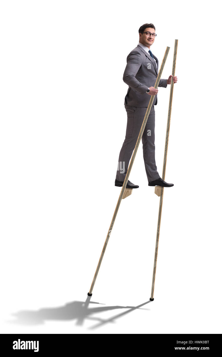 Businessman walking on stilts standing out from the crowd Stock Photo