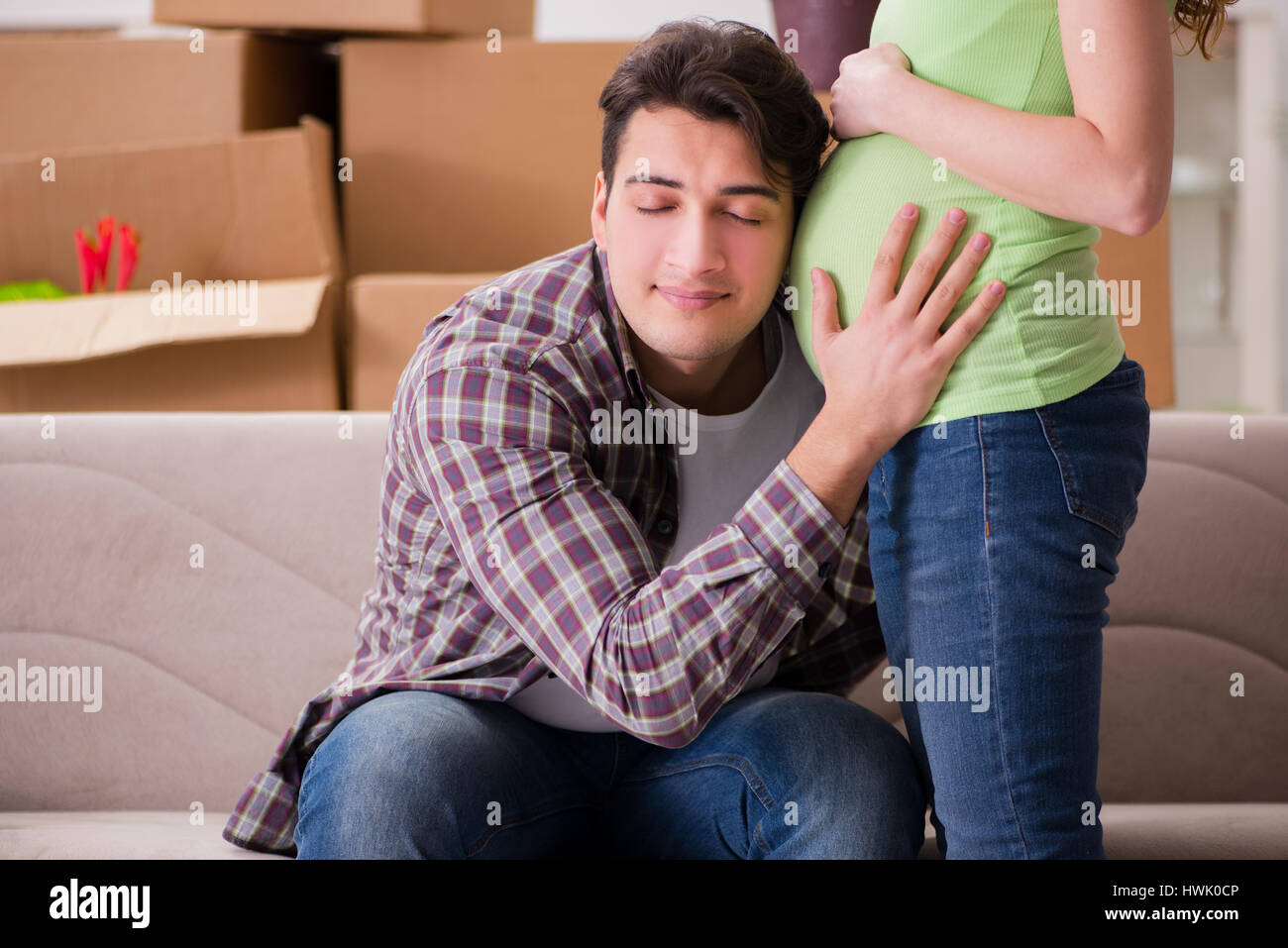 Man Expecting Young couple of man and pregnant wife expecting baby Stock Photo - Alamy