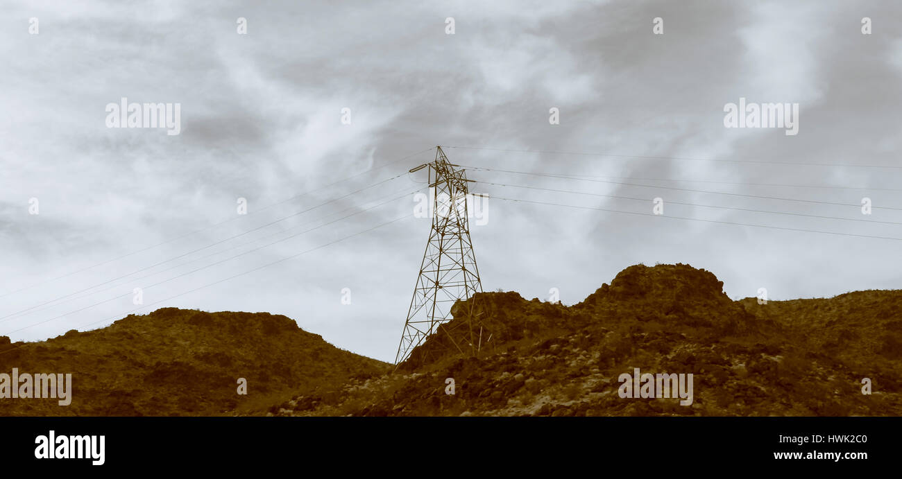 Electricity pylons and lines in a mountain Stock Photo - Alamy