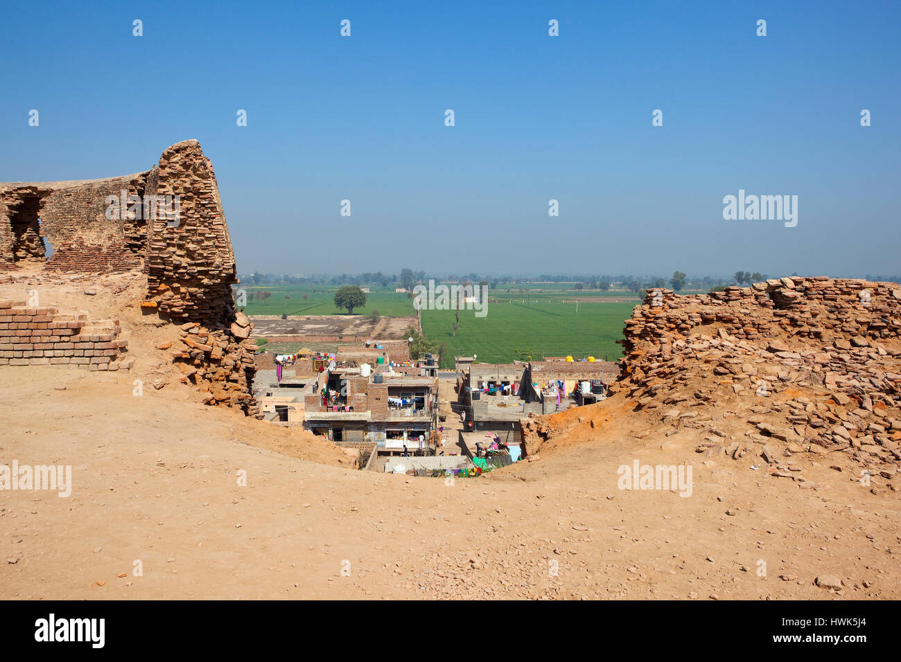 walls being restored with a gap showing daily life in the city of hanumangarh india Stock Photo