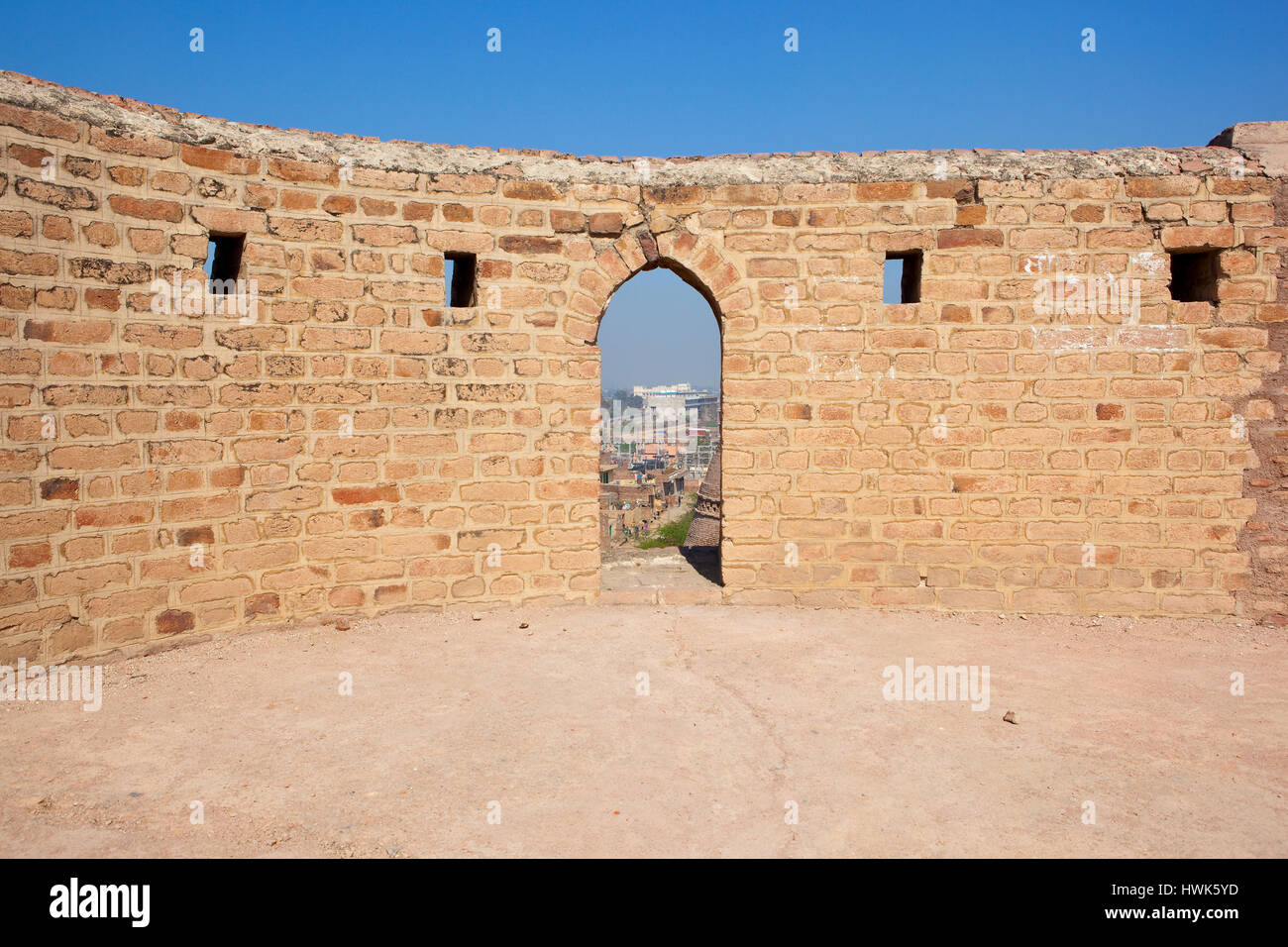an historic archway at bhatner fort hanumangarh india with a view of the town under a blue sky Stock Photo
