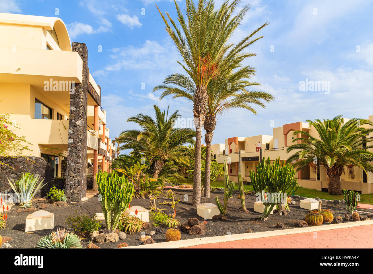 PLAYA BLANCA, LANZAROTE ISLAND - JAN 11, 2015: Apartment hotel building tropical gardens in Playa Blanca village, Lanzarote, Canary Islands, Spain. Stock Photo