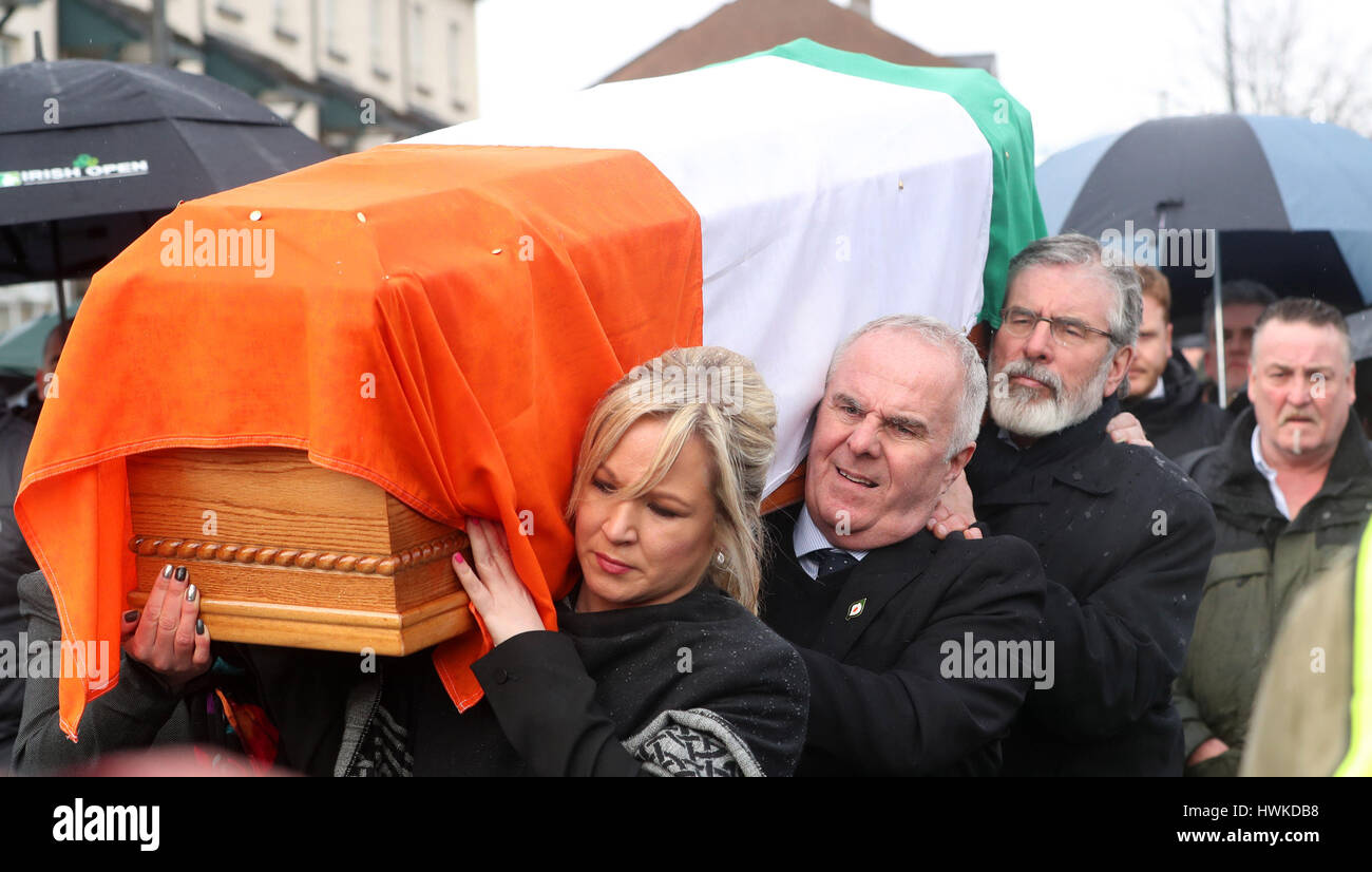 The coffin of Northern Ireland's former deputy first minister and ex-IRA commander Martin McGuinness is carried to his home in Londonderry by Gerry Adams, Raymond McCartney and Michelle O'Neill after he died aged 66. Stock Photo
