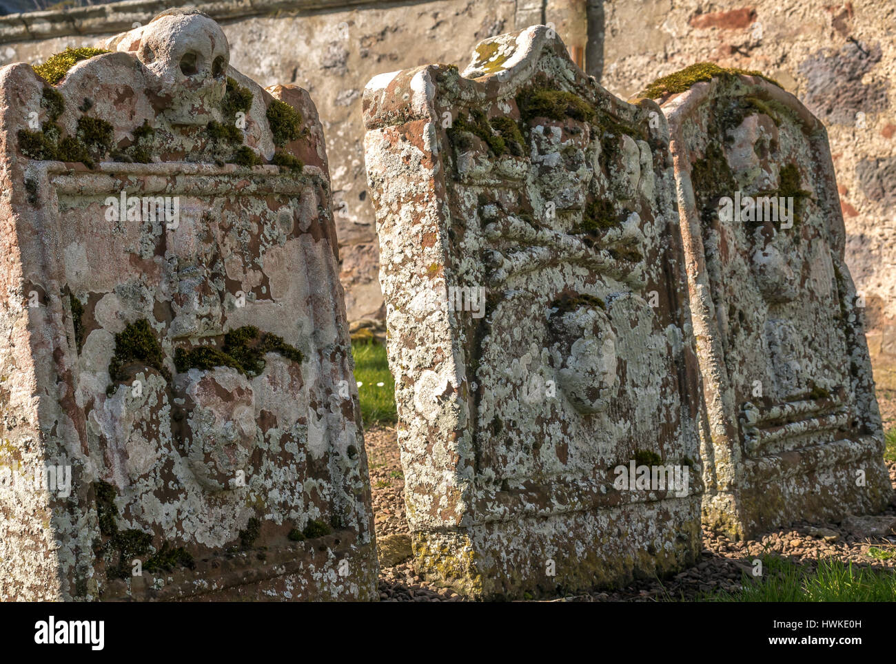 Close up of old lichen covered leaning gravestones, Morham churchyard, East Lothian, Scotland, UK, smallest parish in Scotland Stock Photo