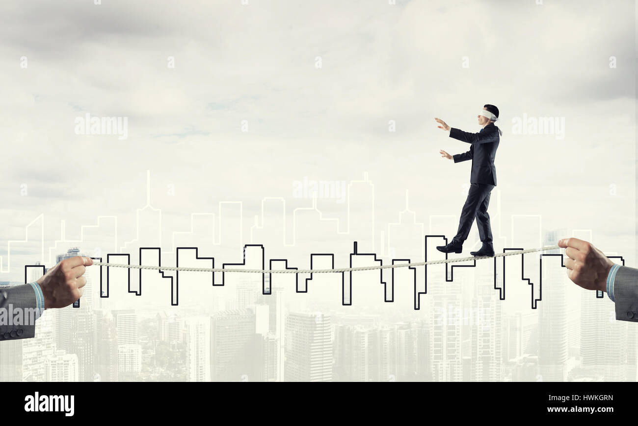 Business concept of risk support and assistance with man balancing on ...