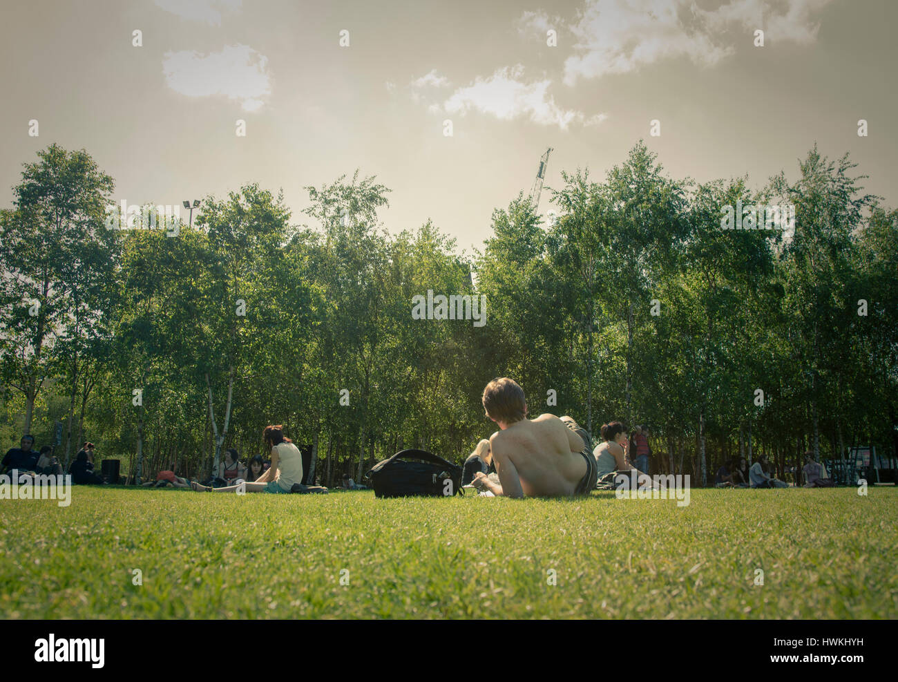People relaxing on the grass in front of the Tate Modern Art Galley London England UK Stock Photo