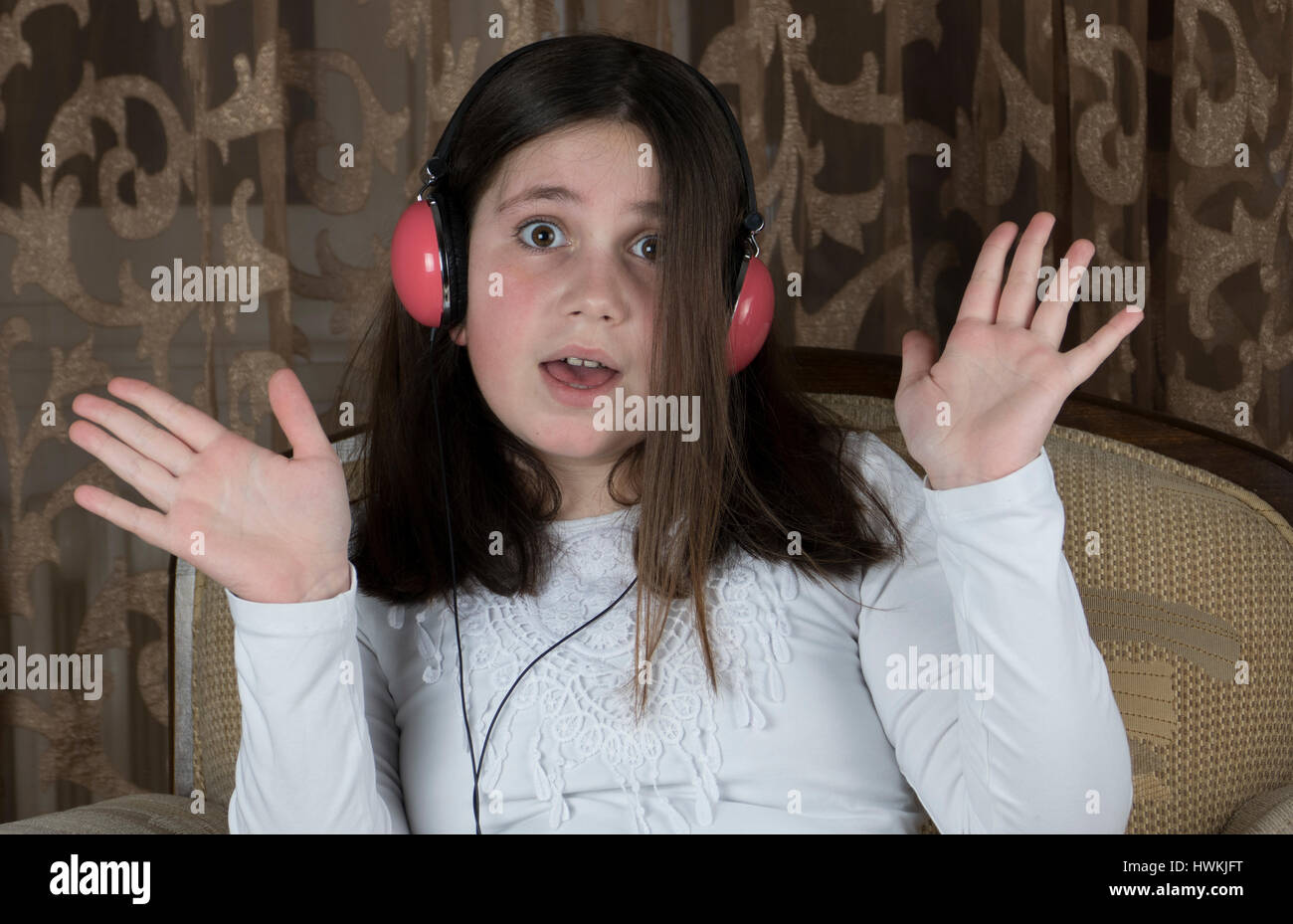 Little girl with headphones listening a music Stock Photo - Alamy