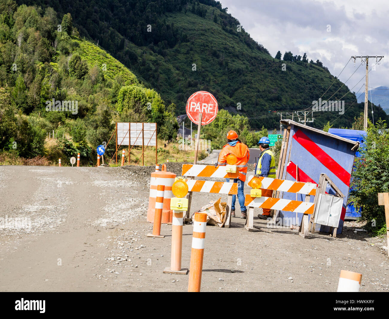 Construction work on the   Carretera Austral road, stop sign, gravel road , forest north of Caleta Tortel,   Patagonia, Chile Stock Photo