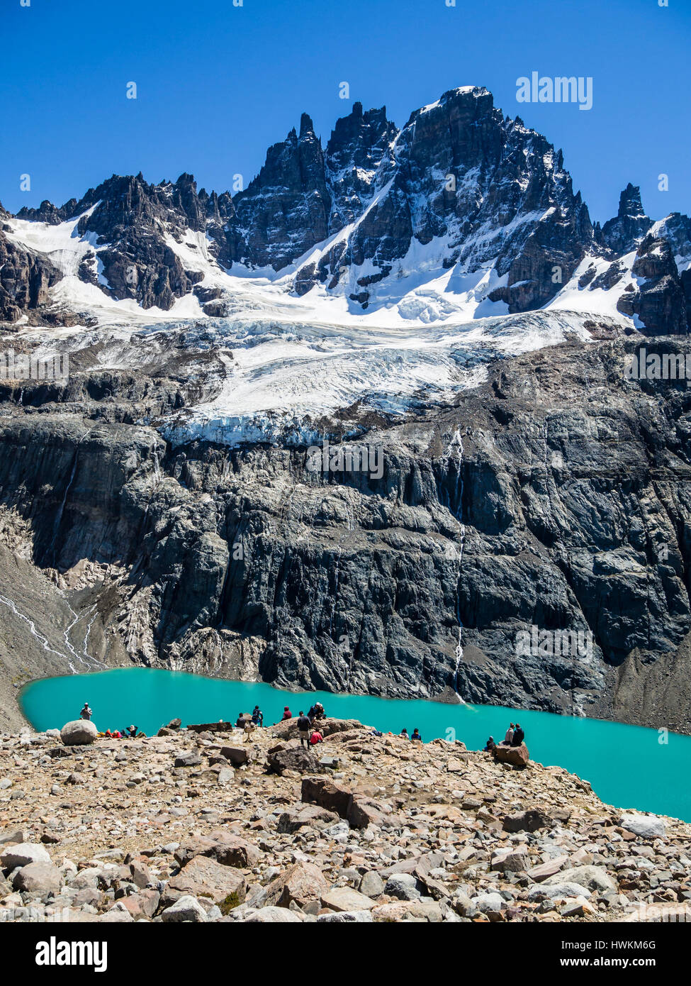 Hikers at the lagoon below mountain Cerro Castillo, view towards glacier and peak Cerro Castillo, nature reserve Cerro Castillo, Reserva Nacional Cerr Stock Photo