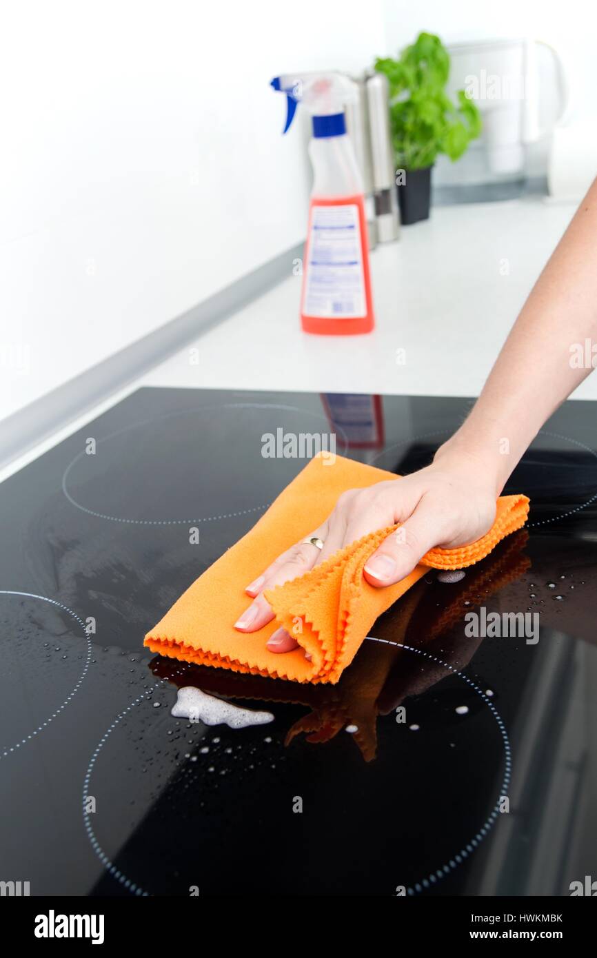 Hand cleaning induction stove Stock Photo