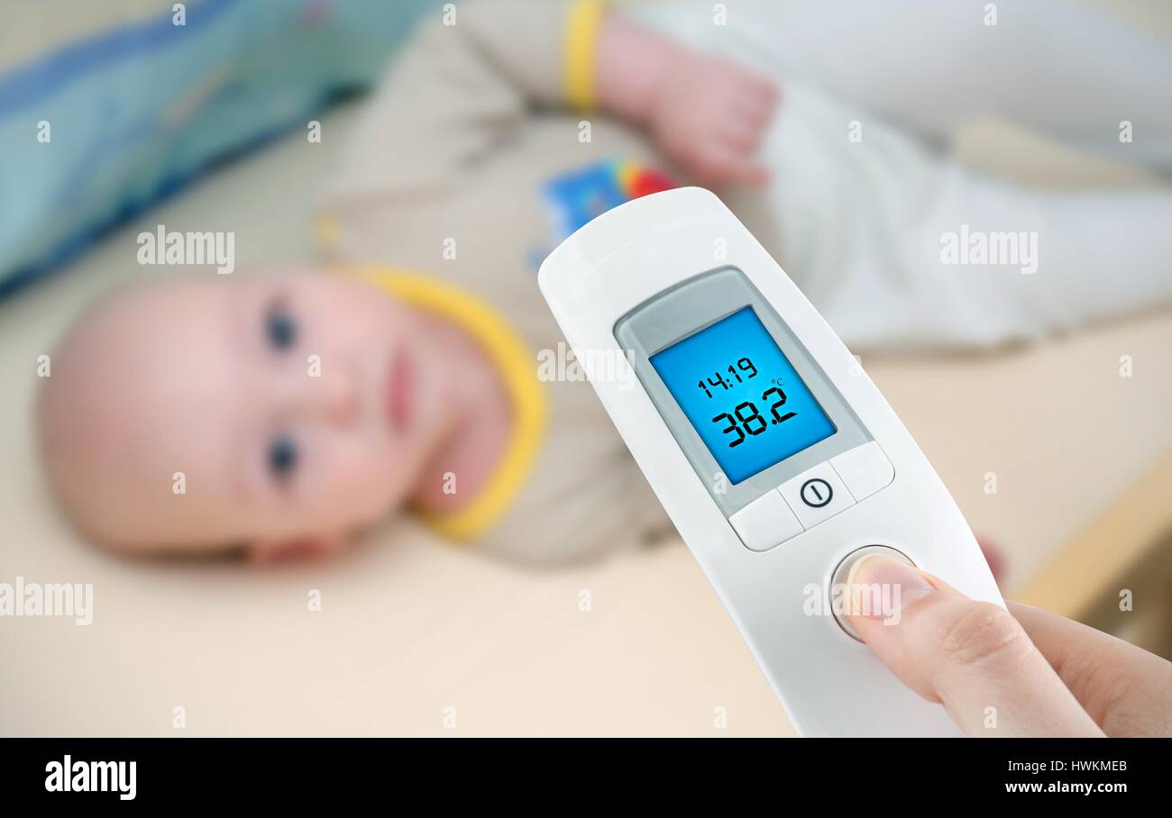 Measuring temperature to a baby with digital thermometer Stock Photo