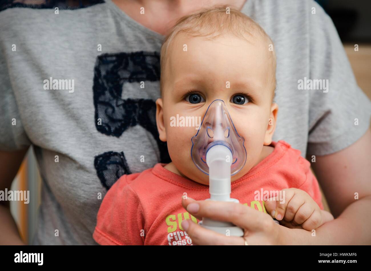 Child making inhalation with mask on his face. Asthma problems concept