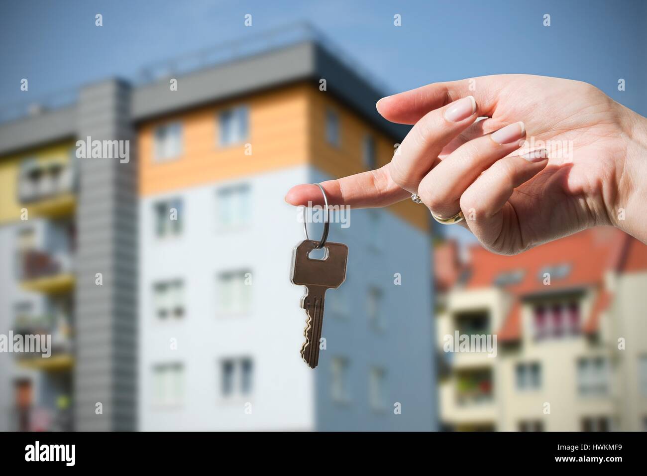 Woman hand holding on finger keys to new house. Stock Photo
