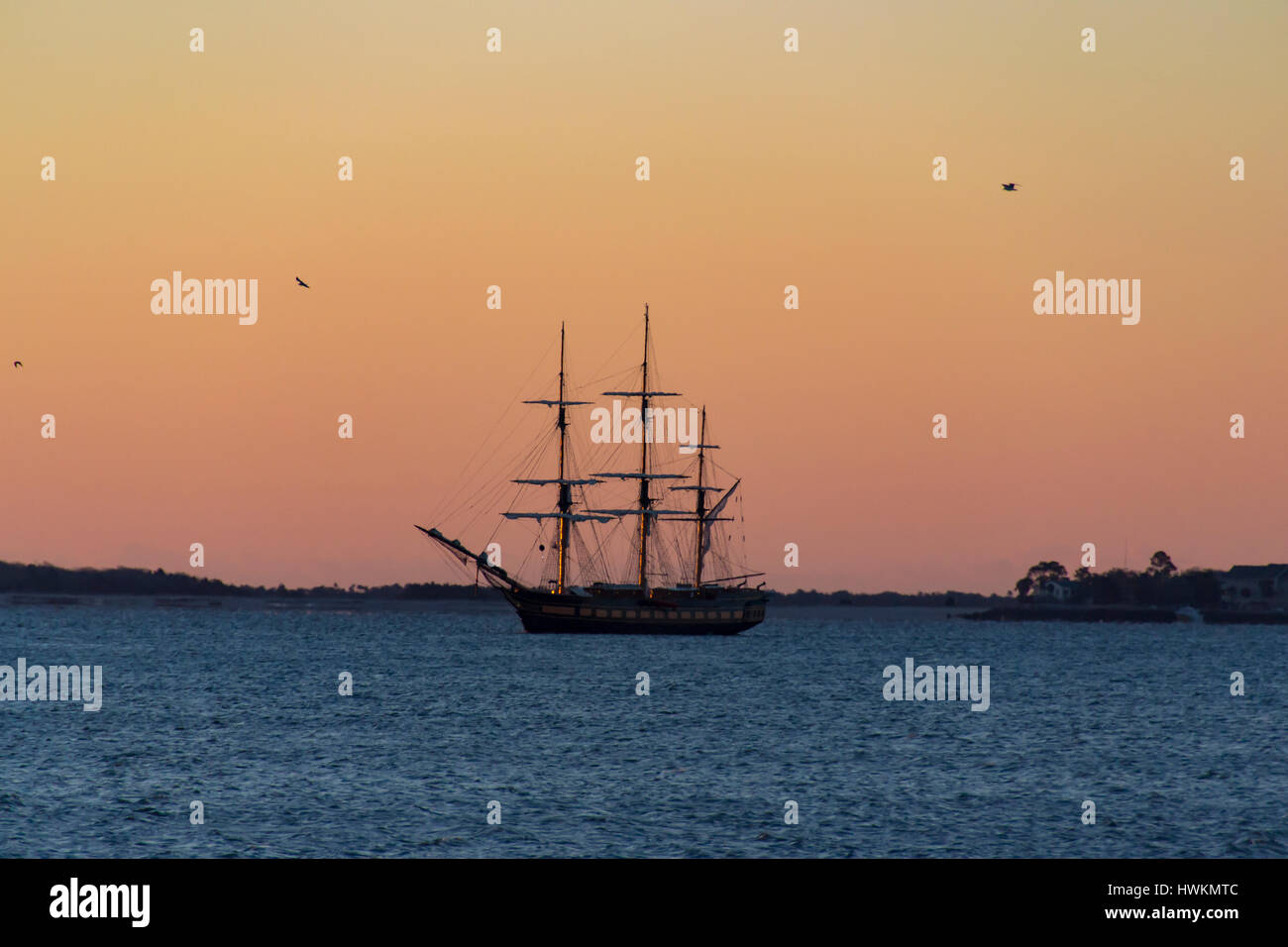 A Brig sits at anchor in Charleston Harbor just before Sunrise Stock Photo