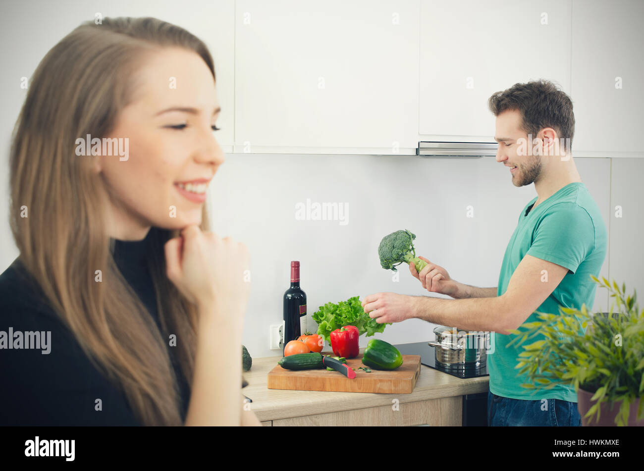 Young couple spends time together in the kitchen. lifestyle couple kitchen cooking home happy breakfast young concept Stock Photo