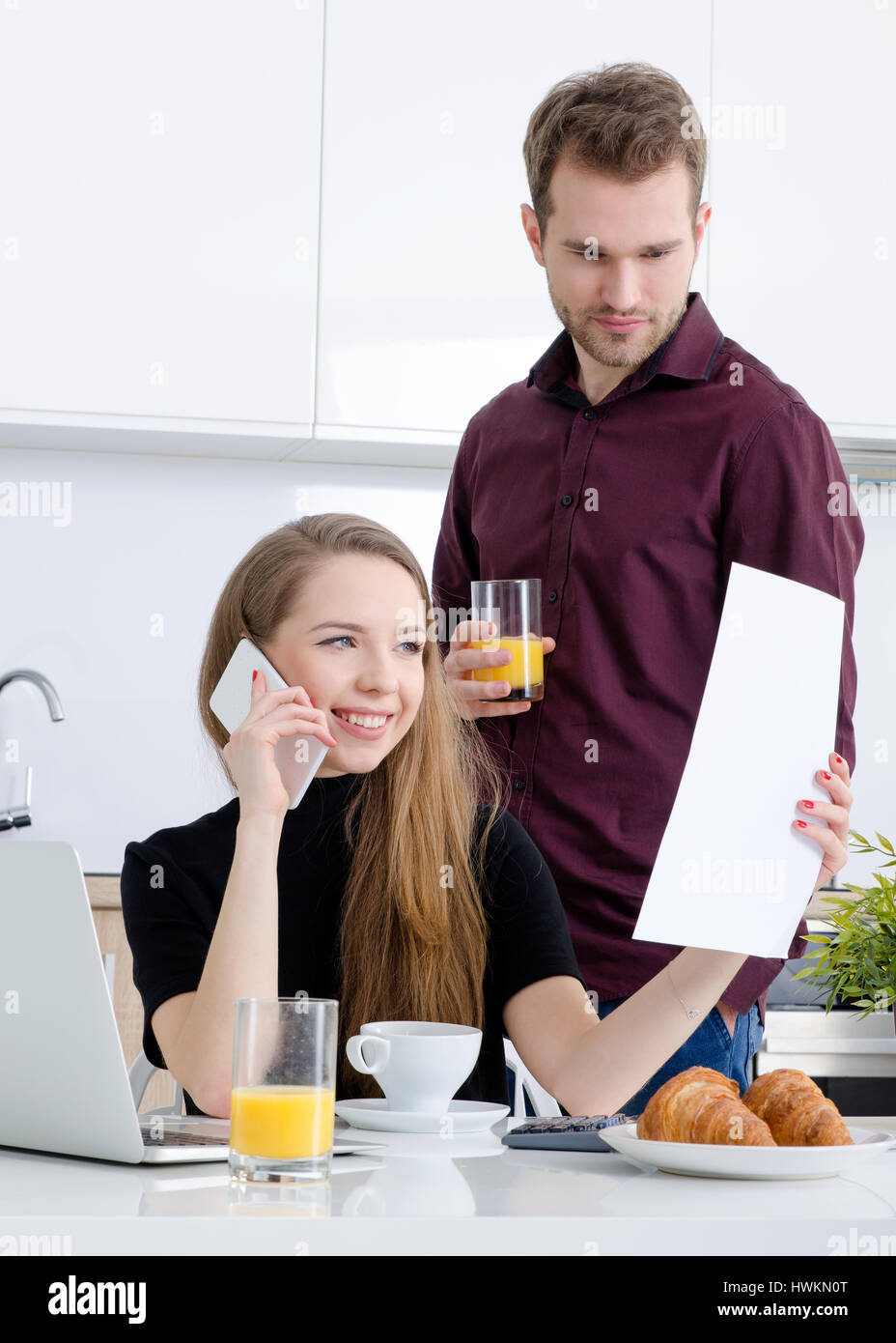 Young businesswoman working at home drinking coffee. home work woman laptop kitchen modern businesswoman couple concept Stock Photo