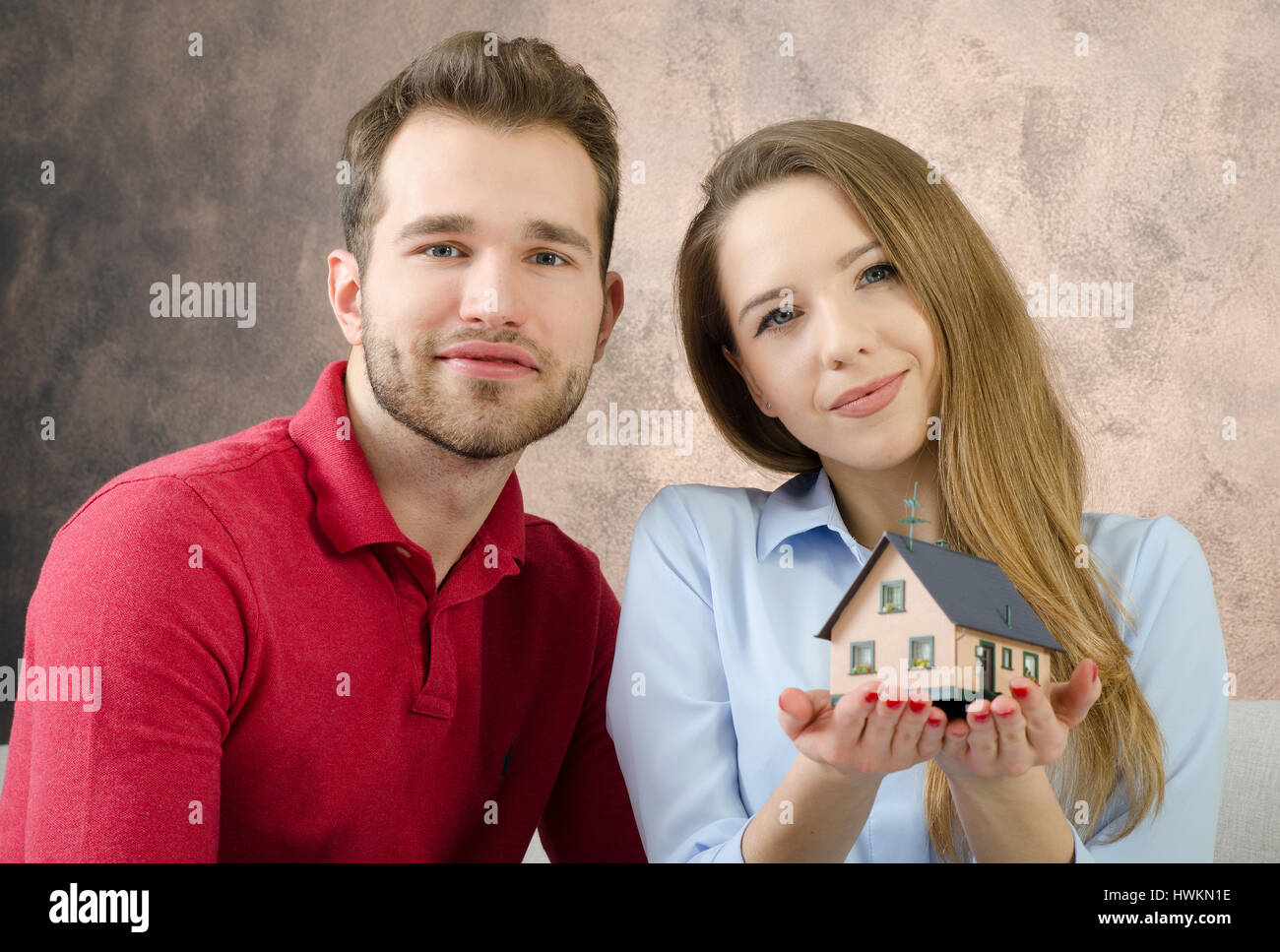Young couple enjoys the purchase of own home. estate buy home young couple buying agree agreement concept Stock Photo