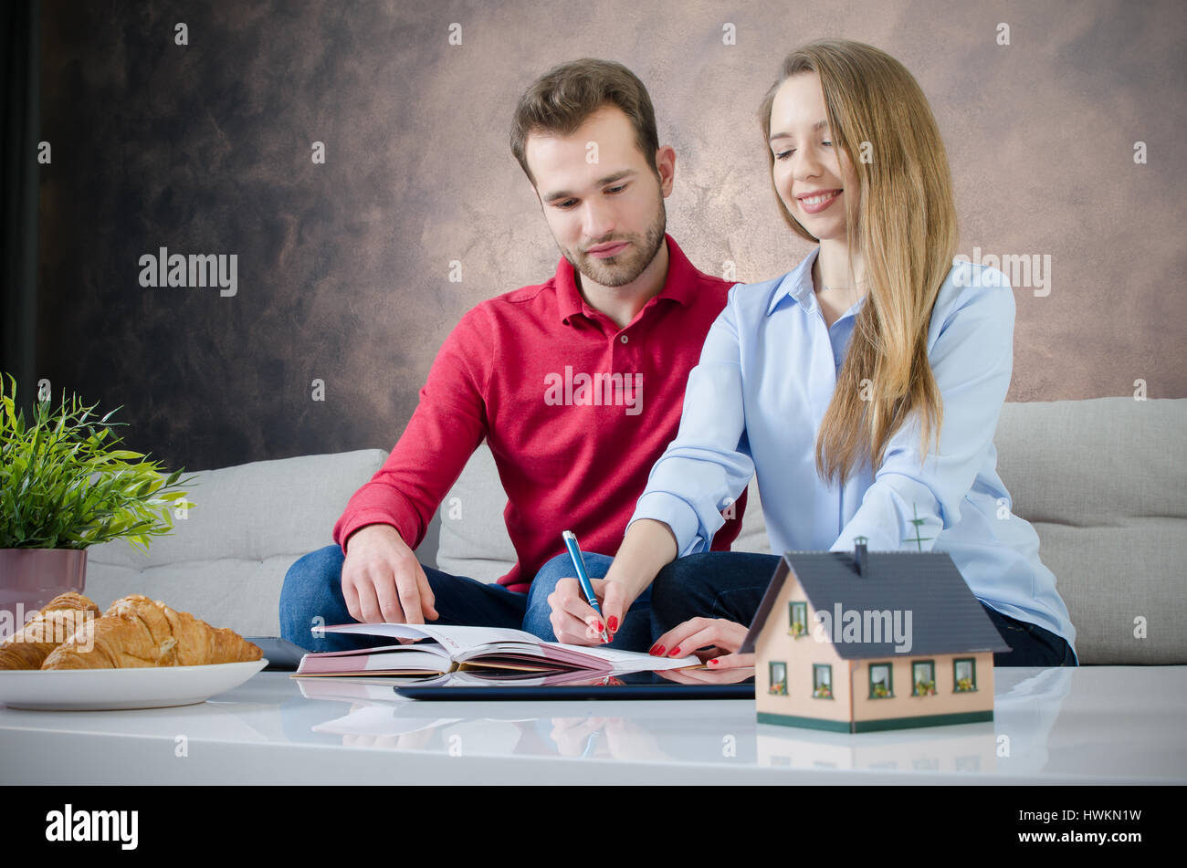 Young couple budget planning for own home. couple saving home marriage planning budget finance concept Stock Photo