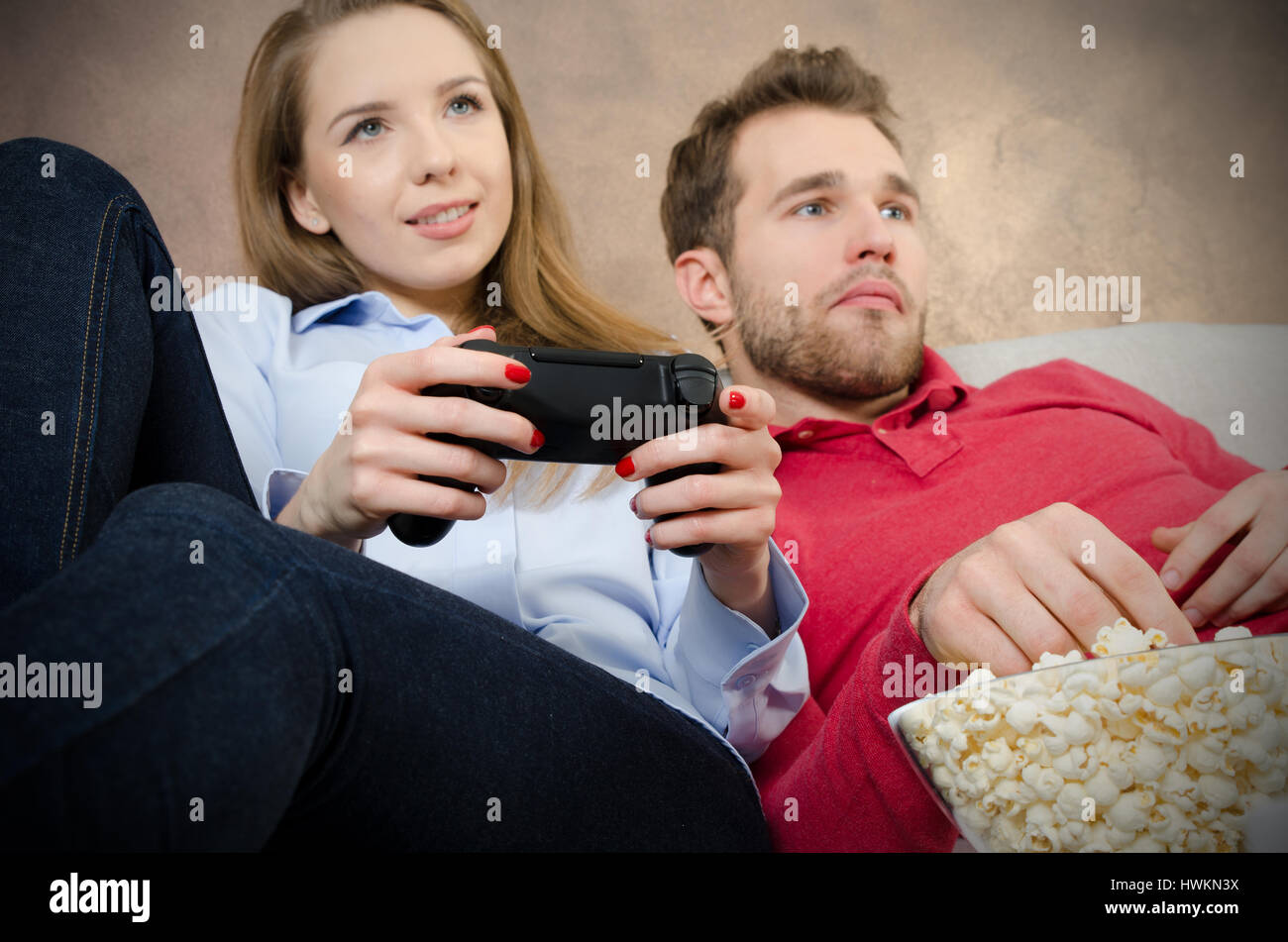 Pair spends free time playing video games. video game couple leisure play console watching gamepad concept Stock Photo